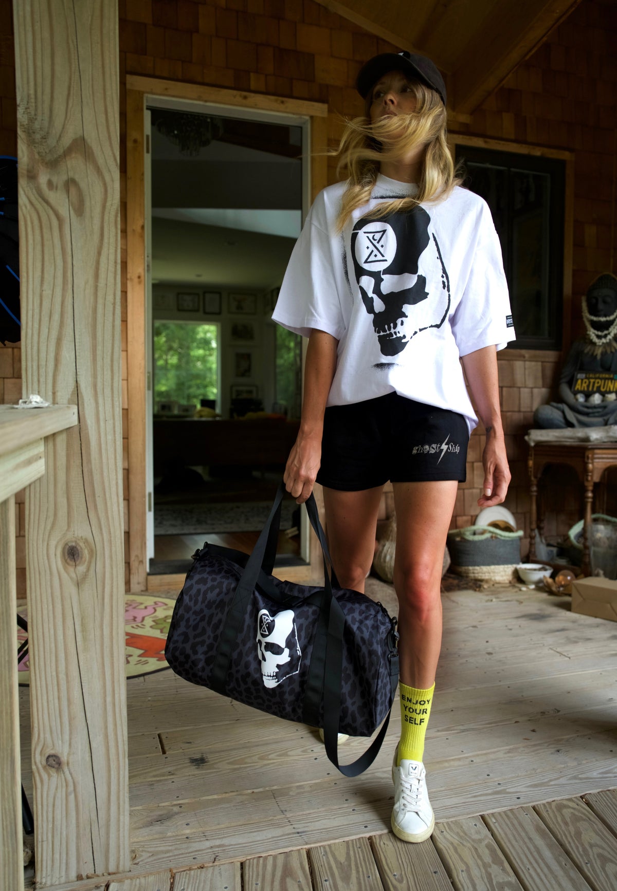 model jacq winter, writer jacq winter, a woman with luggage, woman in a white and black skull shirt
