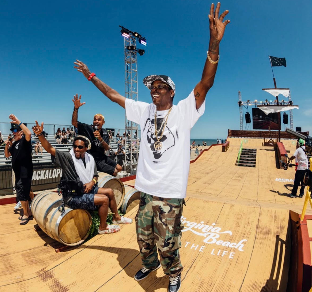 pro skateboarders Kareem Campbell, Manny Santiago, and dominick walker  at jackalope 2026 on a boat deck with arms raised, surrounded by barrels and people, under a clear blue sky.