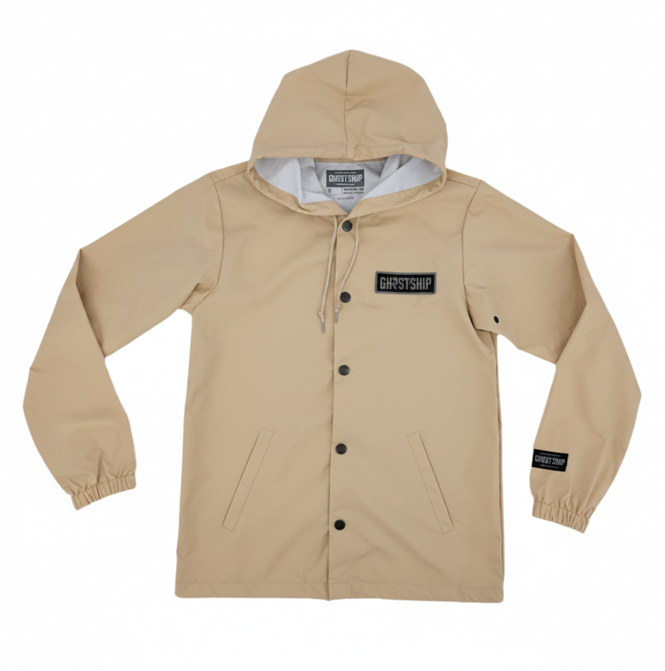 a beige hooded rain jacket with brass buttons and a black and grey "GHOST SHIP" brand patch on the front left chest